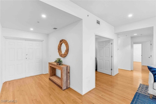 hallway with light hardwood / wood-style floors