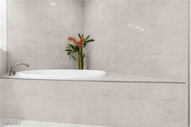 bathroom featuring a relaxing tiled tub