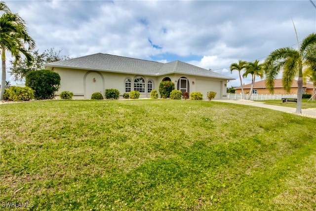 ranch-style house featuring a garage and a front yard