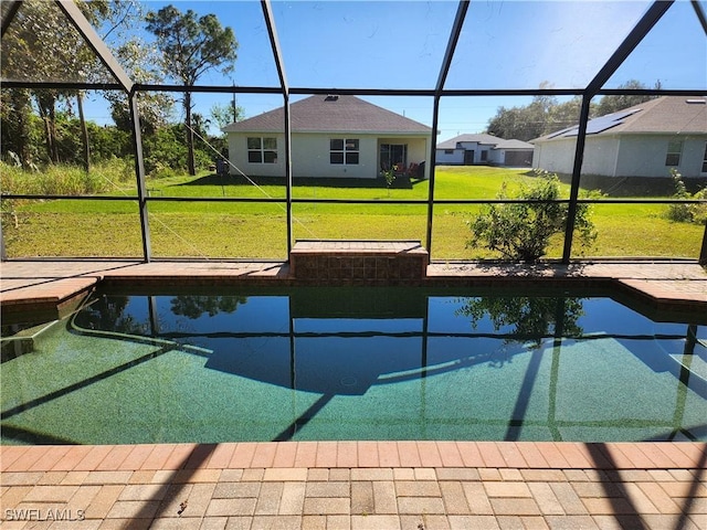 view of swimming pool with a lanai and a lawn