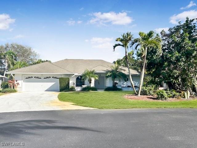 ranch-style home featuring a garage and a front lawn