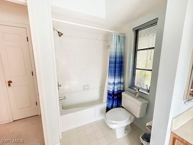 full bathroom featuring vanity, tile patterned flooring, toilet, and shower / bath combo with shower curtain