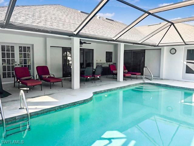 view of pool with a patio, a lanai, and french doors