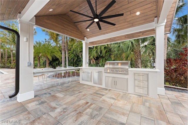 view of patio featuring an outdoor kitchen, a grill, and ceiling fan