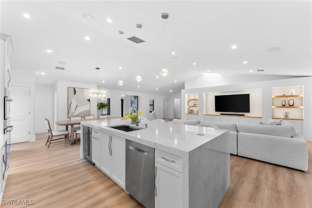 kitchen with decorative light fixtures, a center island with sink, dishwasher, light stone countertops, and white cabinets