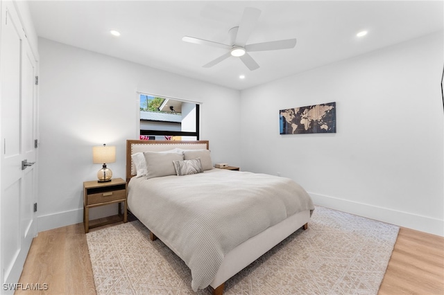 bedroom with hardwood / wood-style floors and ceiling fan