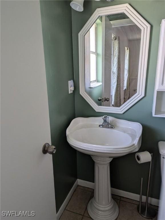 bathroom with tile patterned floors and toilet