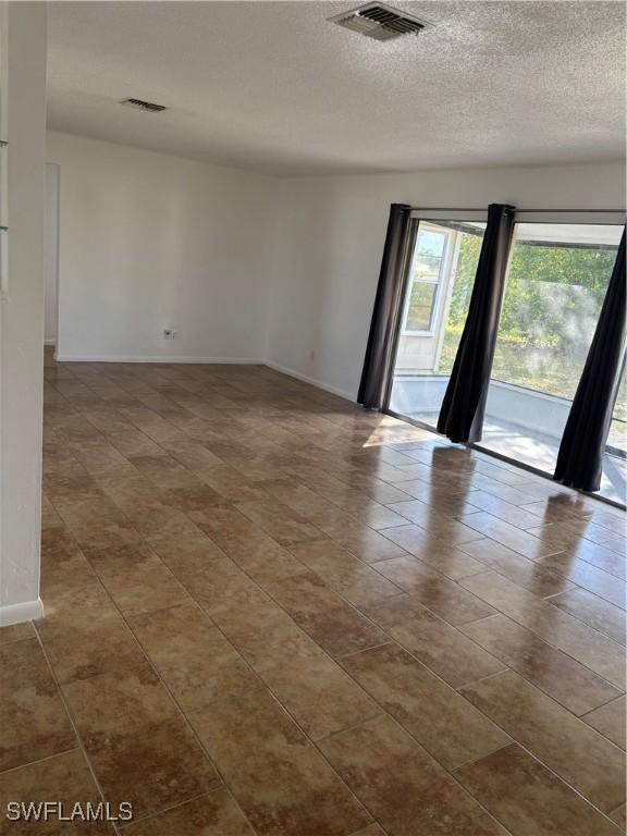 empty room with a textured ceiling