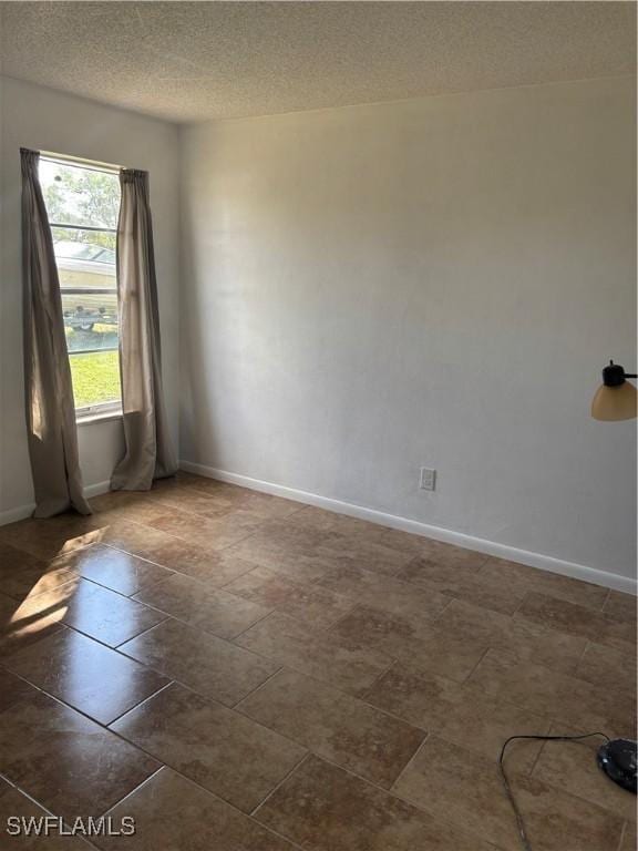 empty room with a textured ceiling