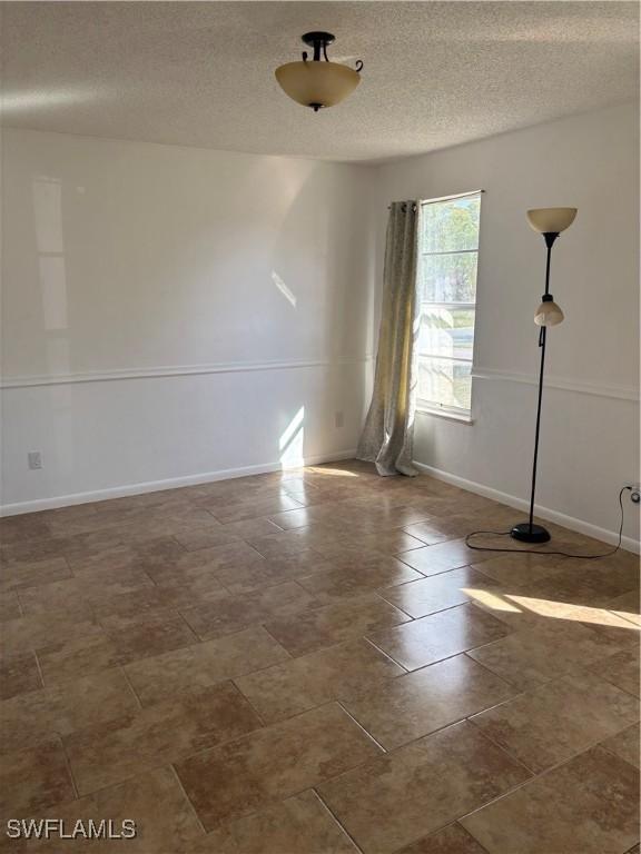 empty room featuring a textured ceiling