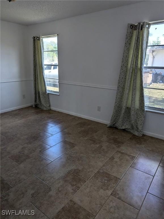 empty room featuring a textured ceiling