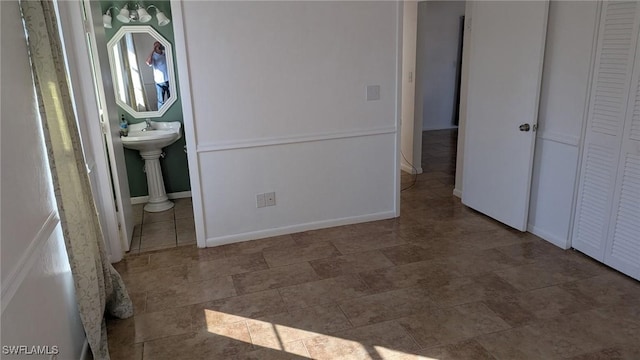 interior space featuring sink and ensuite bath