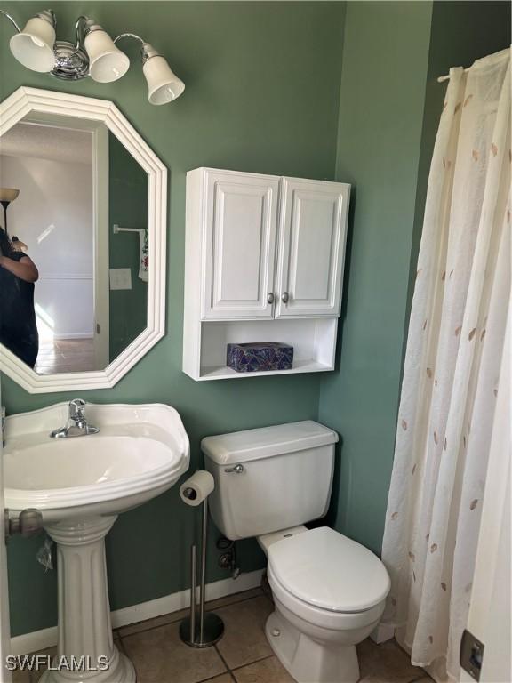 bathroom with tile patterned floors and toilet