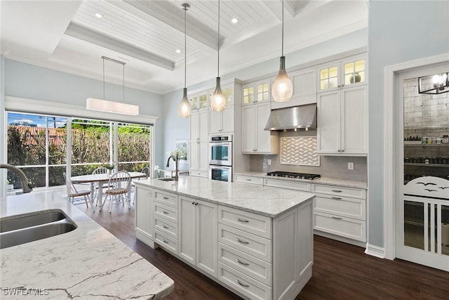 3747 Fountainhead Ln, Naples, FL 34103 - kitchen featuring extractor fan, an island with sink, dark wood-type flooring, beam ceiling, and a high ceiling