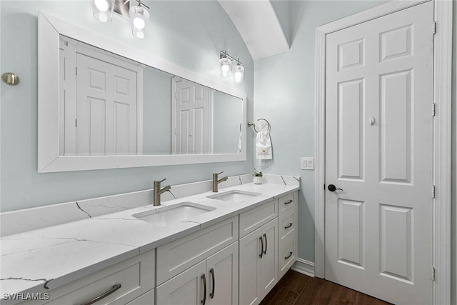 3747 Fountainhead Ln, Naples, FL 34103 - bathroom featuring double vanity and wood finished floors