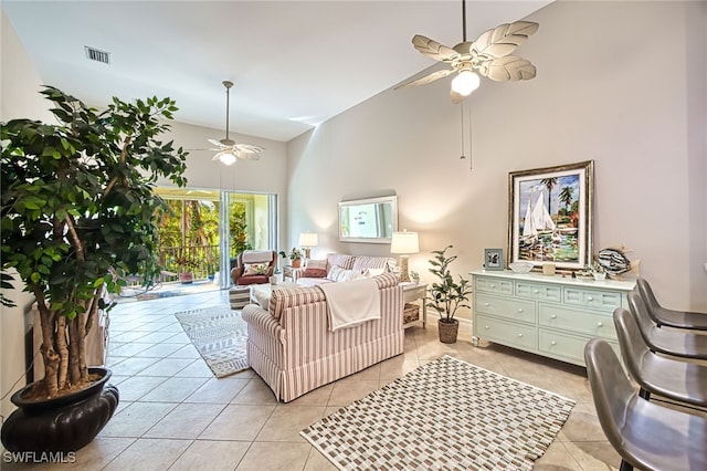 tiled living room with ceiling fan and high vaulted ceiling