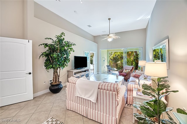 tiled living room featuring a high ceiling and ceiling fan