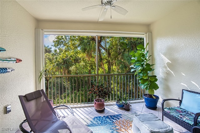 sunroom featuring a wealth of natural light and ceiling fan