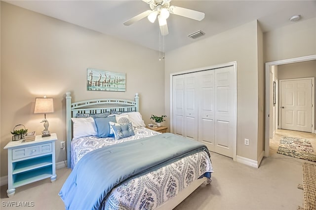 carpeted bedroom featuring a closet and ceiling fan