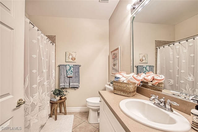 bathroom featuring vanity, tile patterned floors, and toilet