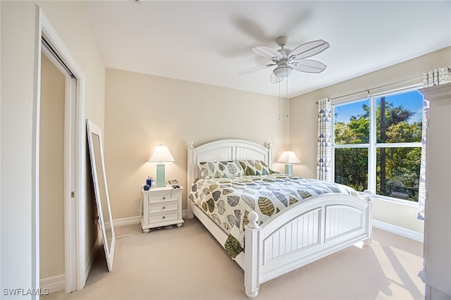 bedroom featuring light colored carpet and ceiling fan