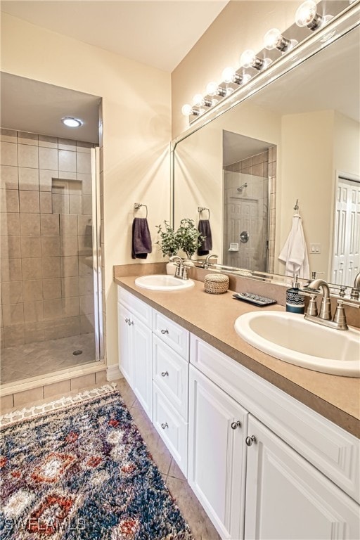 bathroom with walk in shower, vanity, and tile patterned flooring