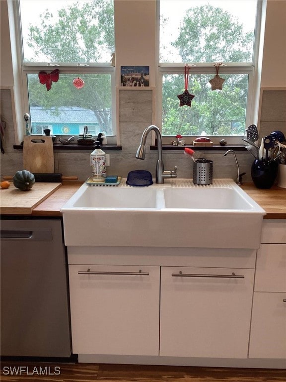 kitchen with white cabinetry, sink, and dishwasher