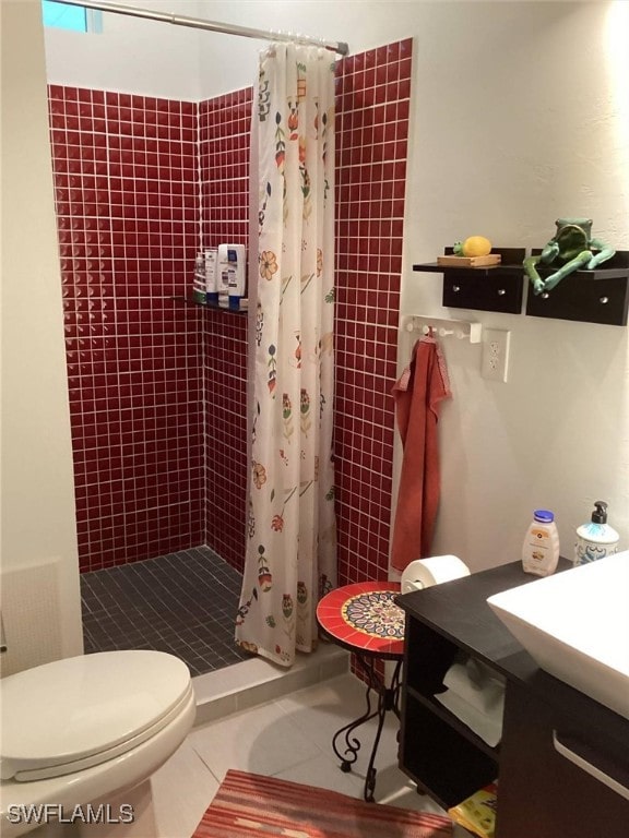 bathroom featuring toilet, vanity, tile patterned floors, and a shower with curtain