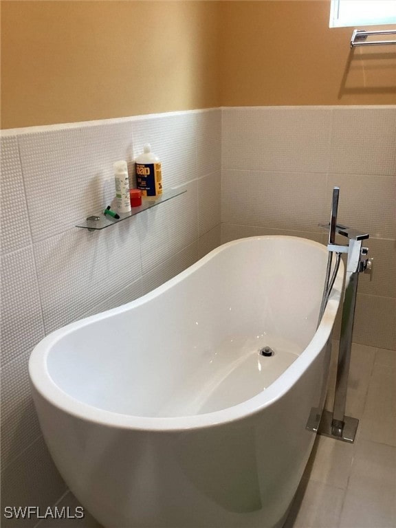 bathroom with a bathing tub and tile walls