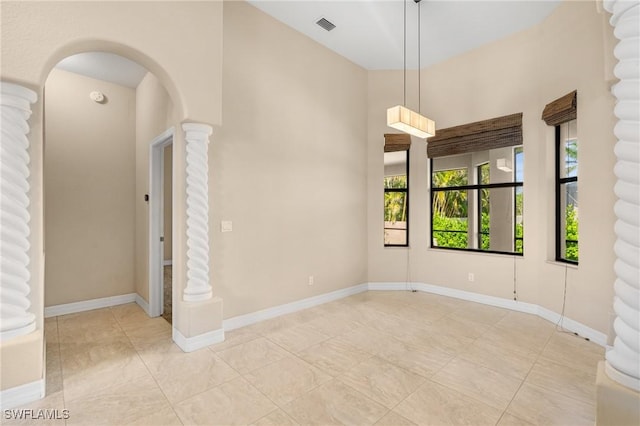 empty room featuring decorative columns