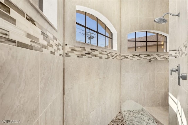 bathroom with a tile shower