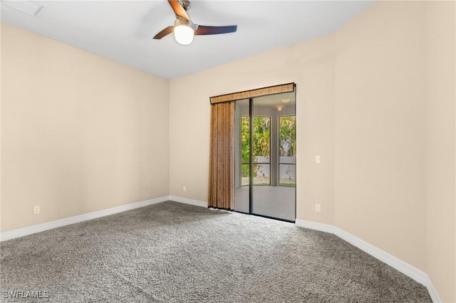 spare room featuring ceiling fan and carpet