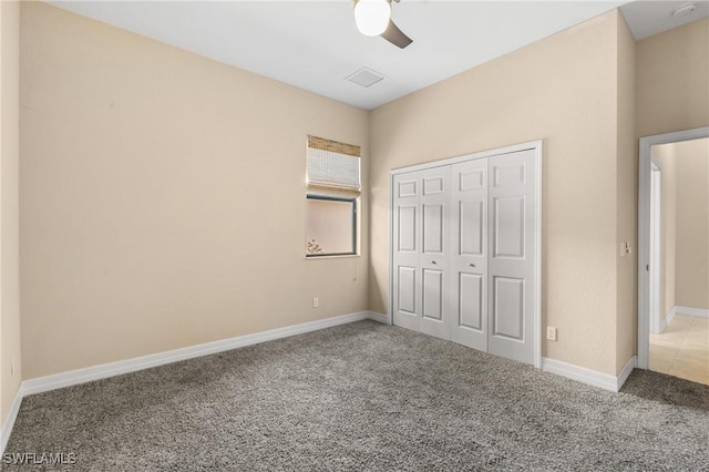 unfurnished bedroom with carpet, a closet, and ceiling fan