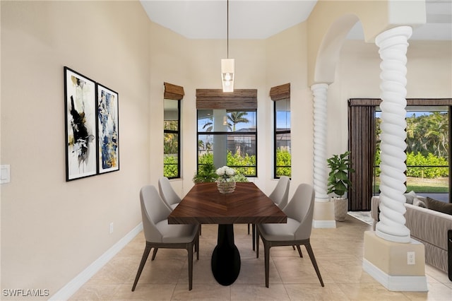 tiled dining room featuring decorative columns