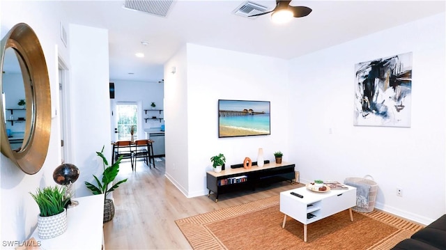 interior space with visible vents, baseboards, light wood finished floors, and a ceiling fan