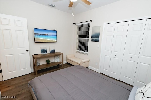 bedroom featuring a ceiling fan, visible vents, wood finished floors, baseboards, and a closet