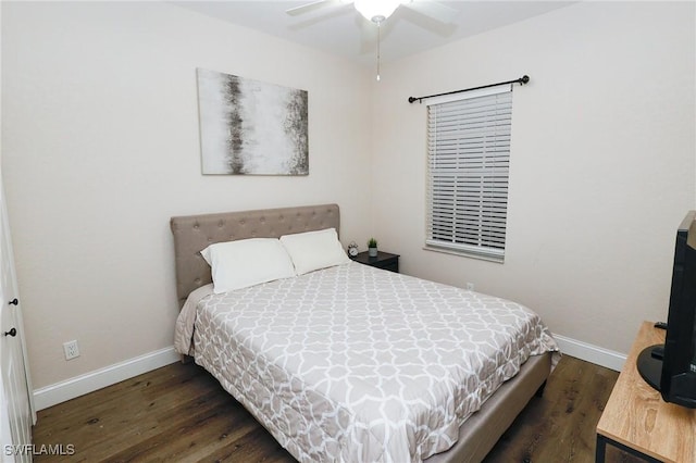 bedroom with wood finished floors and baseboards