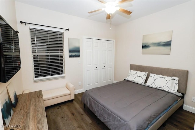 bedroom featuring ceiling fan, wood finished floors, a closet, and baseboards