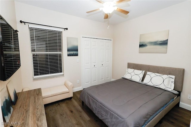 bedroom with a closet, baseboards, a ceiling fan, and wood finished floors