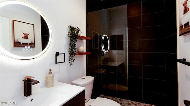 bathroom featuring toilet, walk in shower, and vanity