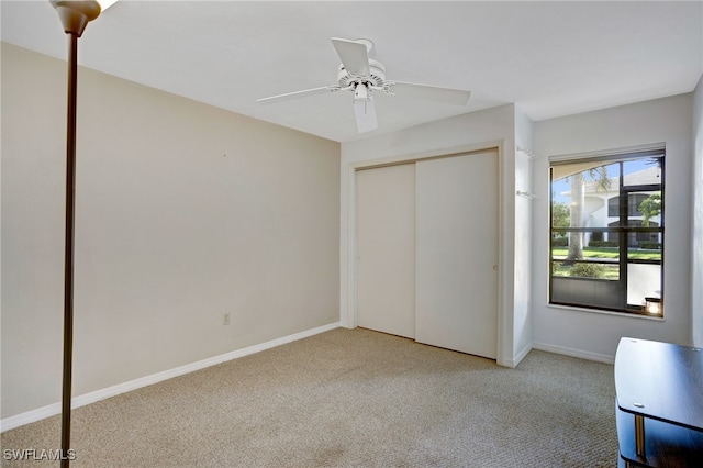 unfurnished bedroom with carpet floors, a closet, and ceiling fan