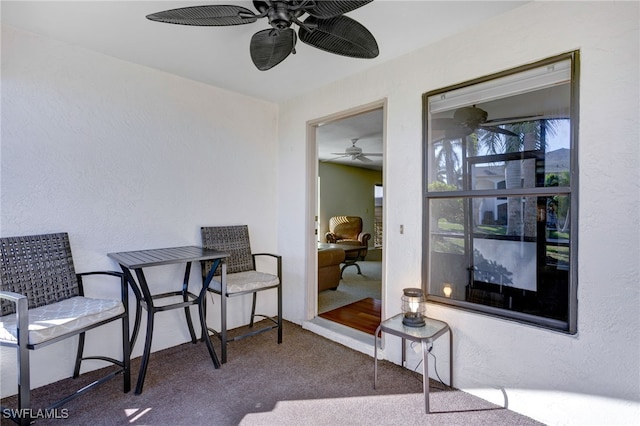 interior space with carpet floors and ceiling fan