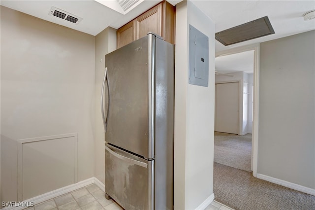 kitchen with light carpet, stainless steel fridge, and electric panel