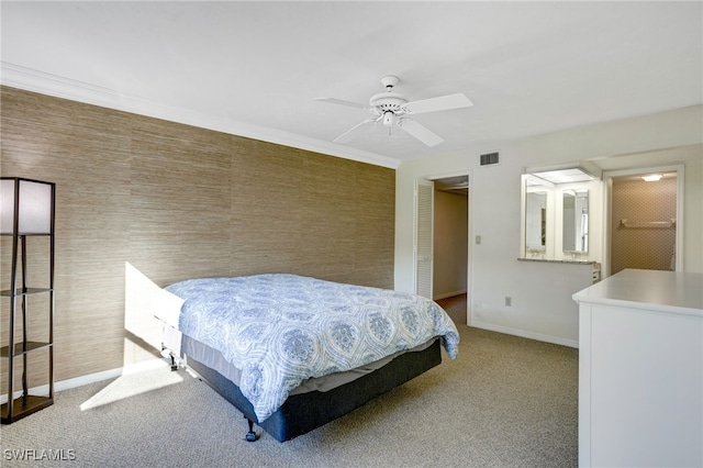 carpeted bedroom with ceiling fan, a closet, and a walk in closet