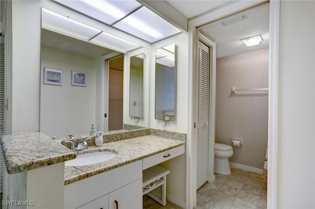 bathroom featuring vanity and toilet