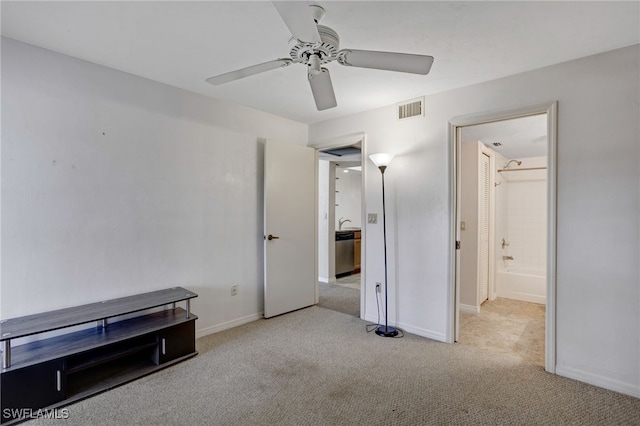 unfurnished bedroom featuring light colored carpet and ceiling fan