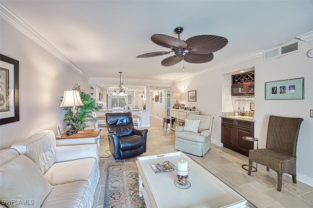 living room featuring ceiling fan, indoor bar, and ornamental molding