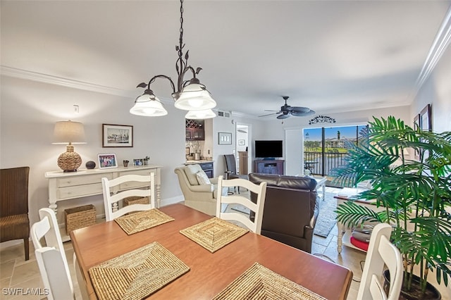 dining space with ornamental molding and ceiling fan