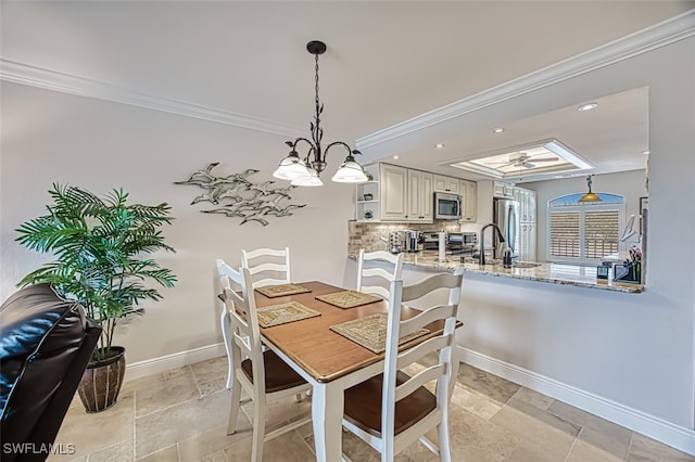 dining area with sink and ornamental molding