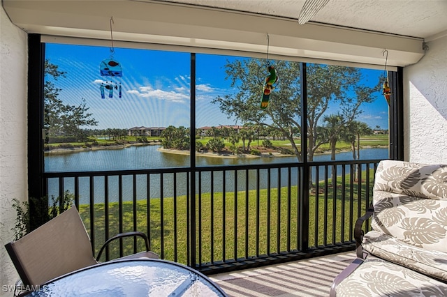 sunroom / solarium with a water view